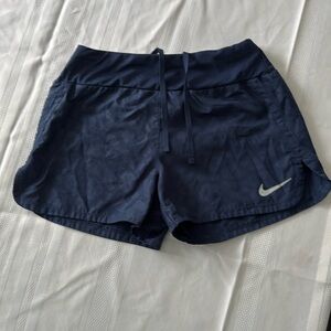Nike running shorts, navy blue with subtle cheetah print